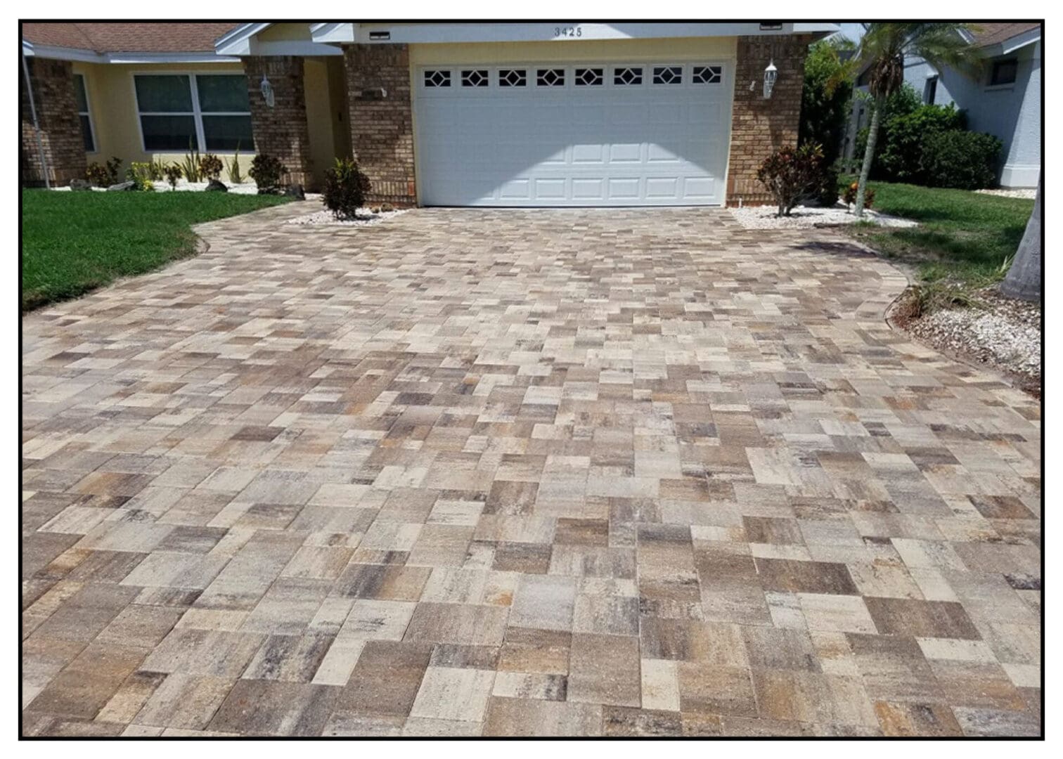 A drive way with white garage door