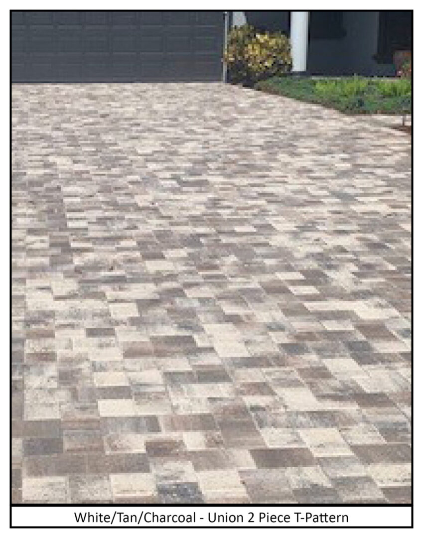 A brick driveway with a house in the background.