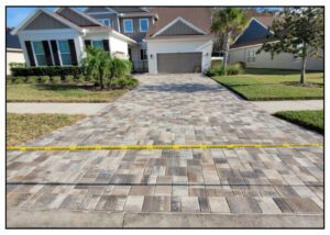 A driveway with a yellow tape.