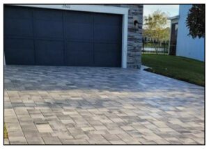 A driveway with brick pavers and a garage.