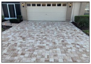 A driveway with brick pavers and a garage.