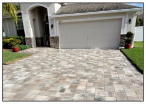 A driveway with brick pavers and a garage.