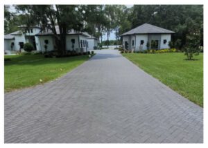 Brick driveway leading to two homes.