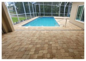 Tan paver patio with a swimming pool.