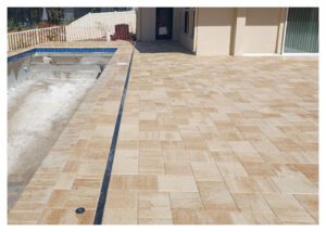 Tan brick pavers around a pool.