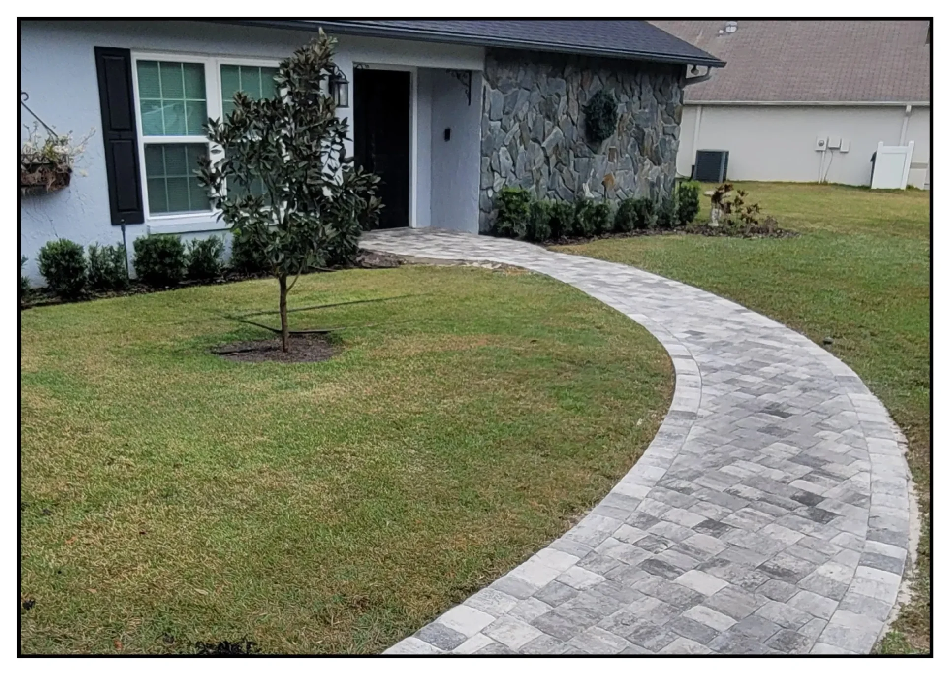 Curved stone pathway leading to house entrance.